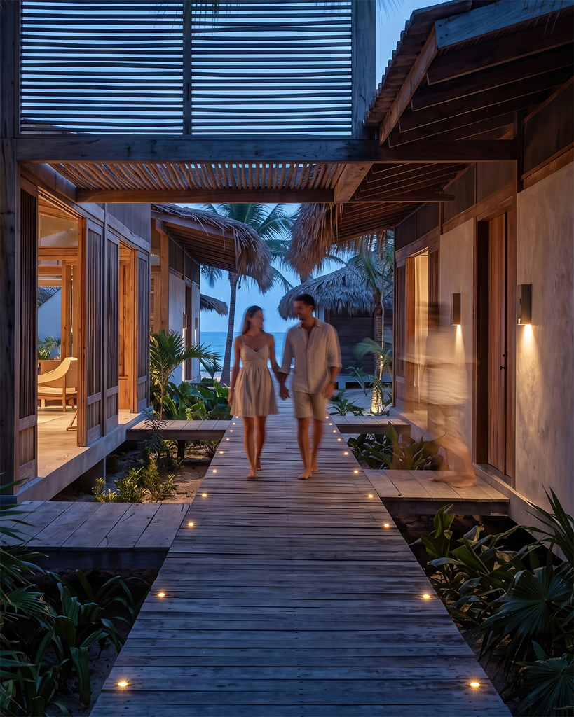 ista exterior nocturna de un render de resort beachfront con una pareja tomados de la mano por la pasarela en madera